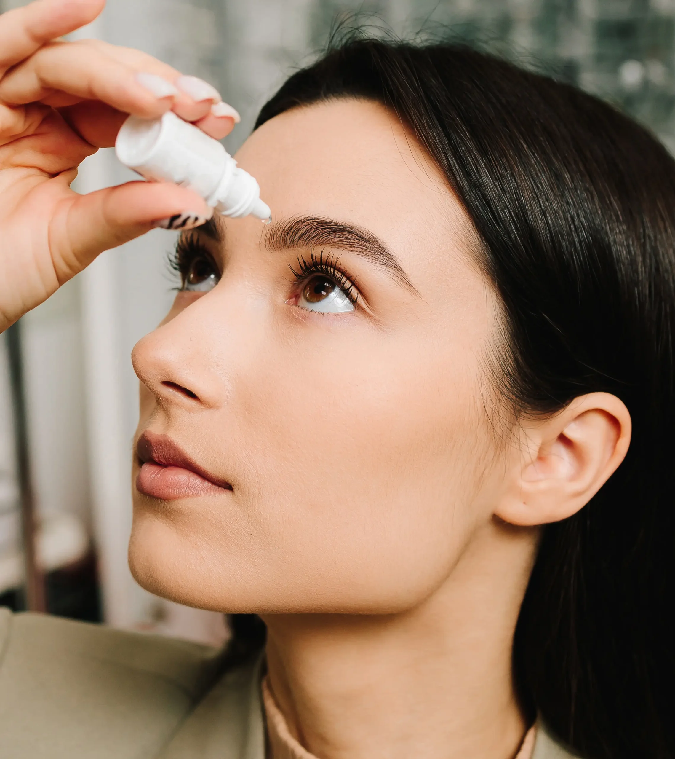 Woman with eye drops