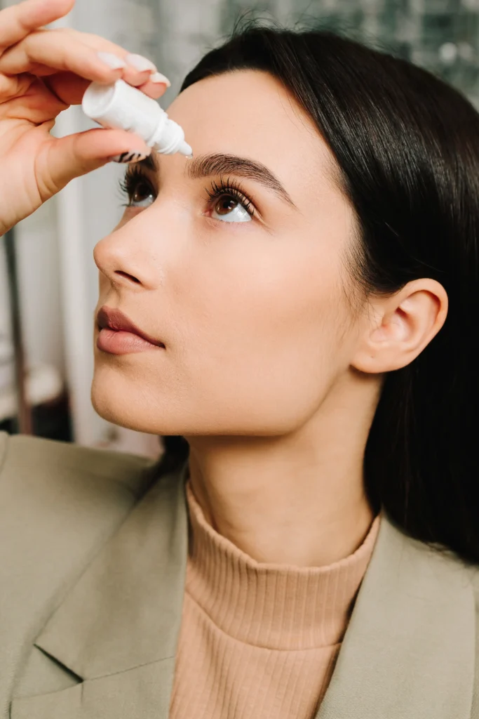 Woman with eye drops